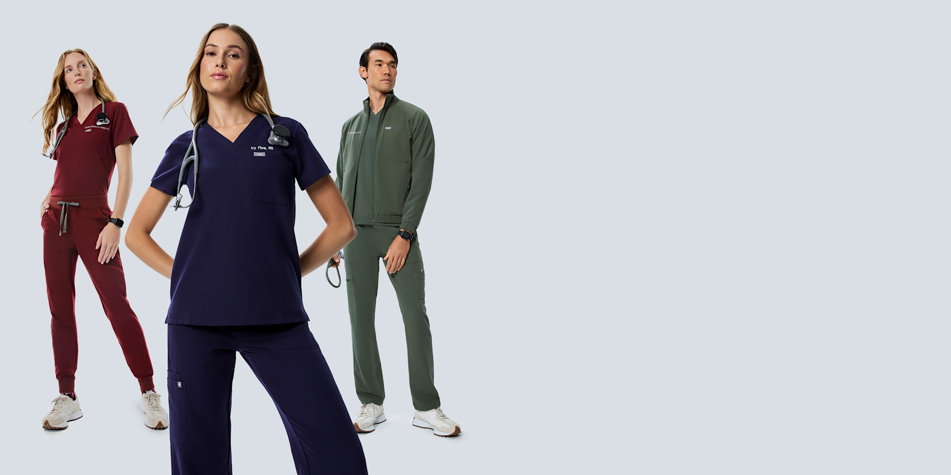 Healthcare professionals wearing FIGS scrubs in navy, burgundy and moss